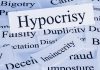 Nazi Tattoo Scandal Explodes in Senate Race A collection of paper cards with various negative terms prominently featuring the word Hypocrisy