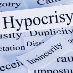 Nazi Tattoo Scandal Explodes in Senate Race A collection of paper cards with various negative terms prominently featuring the word Hypocrisy