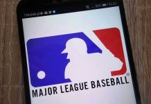 Trump’s Bold Move: Sports Star Pardon! Major League Baseball logo on a smartphone screen.