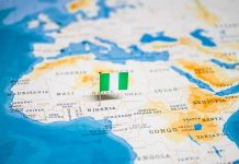 Flag pin marking Nigeria on Africa map.