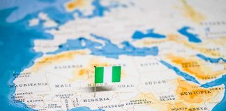 Flag pin marking Nigeria on Africa map.