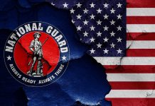 National Guard logo over a distressed American flag.