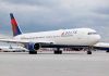 Delta Flight Emergency Exposes HORRIFYING Passenger Behavior Delta Airlines airplane on airport runway cloudy sky