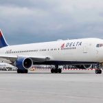 Delta Flight Emergency Exposes HORRIFYING Passenger Behavior Delta Airlines airplane on airport runway cloudy sky