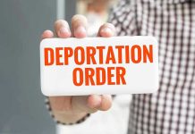 EXPEDITED Deportation: No More Delays! Hand holding sign with Deportation Order text.