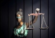 Violent Outburst: Anti-Conservative Charges FILED Blindfolded Lady Justice statue holding scales behind bars
