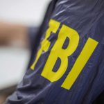 FBI Impersonators: Massive Scam Targeting Victims Jacket with FBI letters in yellow