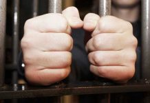 Rob Reiner’s Son Nick On Suicide Watch Hands gripping jail cell bars tightly.