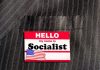 House Vote EXPOSES Democrats’ Socialist Drift Hello my name is Socialist name tag on suit.