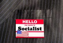 House Vote EXPOSES Democrats’ Socialist Drift Hello my name is Socialist name tag on suit.