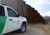 Why Border Issues Keep Getting Ignored in Senate Border protection vehicle near a large metal fence.