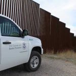 Why Border Issues Keep Getting Ignored in Senate Border protection vehicle near a large metal fence.