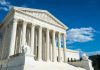 Affirmative Action Fallout Hits Colleges Building with columns under a blue sky.