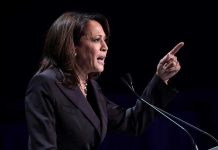 Kamala Harris Reveals What Democrats Don’t Want Exposed Person speaking at podium with raised finger.