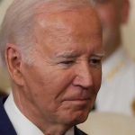 Biden Economy CRUSHED in Trump’s New Report Card Man in a suit looking thoughtful.