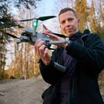 Drone Drops LUXURY Feast Into Prison Yard Person holding a drone in a forest.