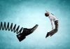 Holiday Layoffs Surge: Executives Pocket Bonuses Man gets kicked by oversized shoe on spring.