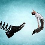 Holiday Layoffs Surge: Executives Pocket Bonuses Man gets kicked by oversized shoe on spring.