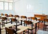 Why Single-Sex Education Is Being Reconsidered Empty classroom with desks, chairs, and whiteboard.