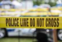 Horrific Suburban Attack Shocks Georgia Yellow police line tape with Do Not Cross.