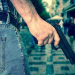 Another “Safe” Blue-State Neighborhood Turns Deadly Person holding a gun in a crowded street.