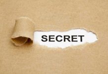 Rising Democrat Star’s Hidden Stock Scandal A torn piece of brown paper revealing the word SECRET underneath