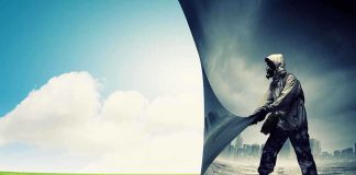 A person in a gas mask pulling back a curtain revealing a polluted cityscape