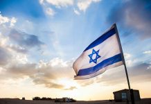 Controversial Swastika Display Outrages Jewish Groups Israeli flag waving against a sunset backdrop with clouds