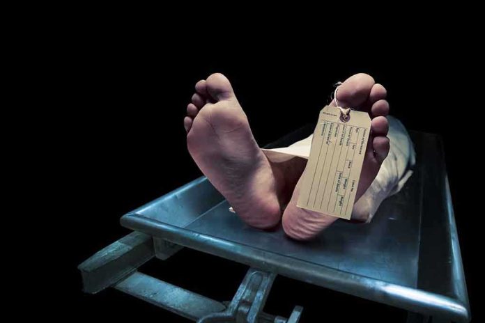 shutterstock_192399461.jpg Feet of a deceased person on a coroners table with an identification tag