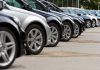 Shocking FTC Case: Minority Car Buyers Cheated! A row of parked black and silver cars in a dealership