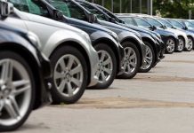 Shocking FTC Case: Minority Car Buyers Cheated! A row of parked black and silver cars in a dealership