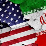 Hidden Pentagon Moves – Headed For Iran Ground War? Cracked American and Iranian flags on a wall.