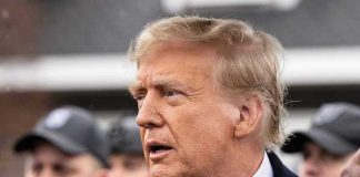 Holy War Rhetoric Surrounds Trump Iran Push Man in suit and red tie speaking outside.