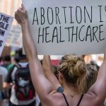 Court Slapdown Upends Menstrual Leave Push Protestors holding signs about womens rights and healthcare.