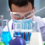 Zombie Cells in Urine? Wild New Lung Cancer Test! Scientist conducting an experiment with blue liquids in a laboratory