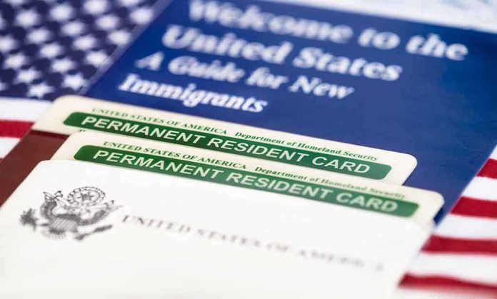 shutterstock_232231384 A guide for new immigrants alongside permanent resident cards and an American flag
