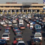 Canadian Visitor Exodus SLAMS U.S. Border Towns A crowded parking lot filled with cars near a border crossing