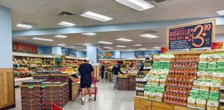 Grocery Prices SOAR: Families Stretched Thin Interior of a grocery store with customers shopping for fresh produce