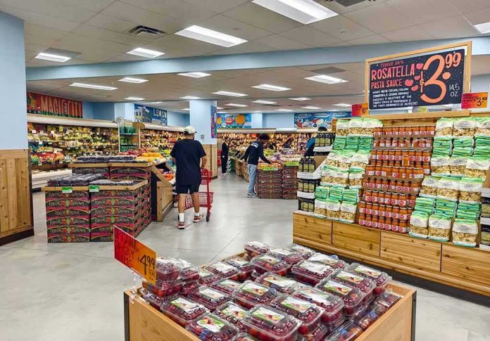 shutterstock_2494030155-1 Interior of a grocery store with customers shopping for fresh produce