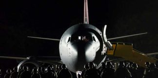 Pentagon Hides 82nd Airborne’s Real Destination Soldiers boarding aircraft at night with staircase