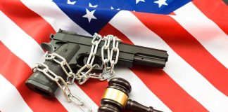 Court Says Suppressors Fit the 2A Text A handgun chained and placed on an American flag with a gavel nearby