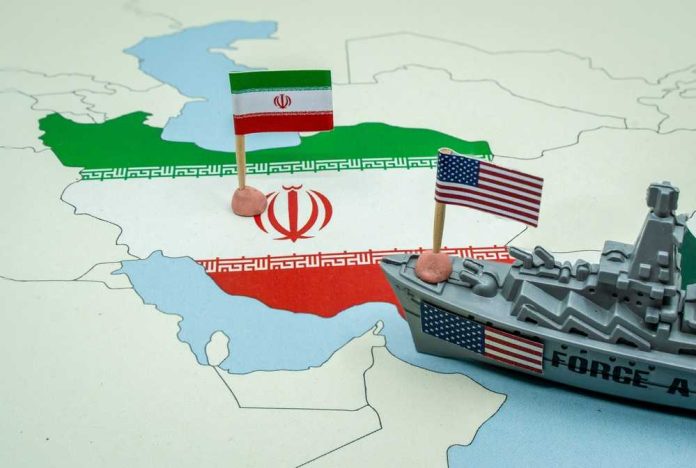 shutterstock_2725505183 A map of Iran with flags of Iran and the United States and a toy military ship