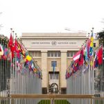 United Nations building with international flags displayed outside
