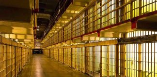 Taxpayer Revolt Hits Missouri Prisons Empty hallway between rows of prison cells.