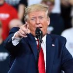 Trump’s Hands-On Money Operation: ‘The Boss Wants This Money’ Man in suit pointing, speaking at a rally.