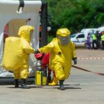 Hazmat Over Hot Sauce Hazmat-suited workers exit a decontamination tent