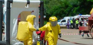 Hazmat Over Hot Sauce Hazmat-suited workers exit a decontamination tent
