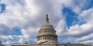 War Cash, Voting Crackdown—Debt Explodes United States Capitol building under a partly cloudy sky