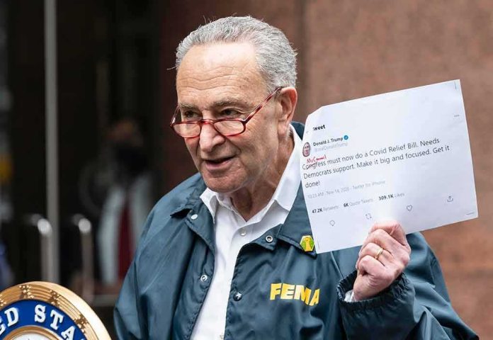 shutterstock_1854673714 man in FEMA jacket holding a printed tweet