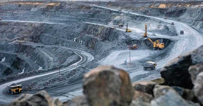 Open-pit mine with haul trucks and excavators on terraced roads